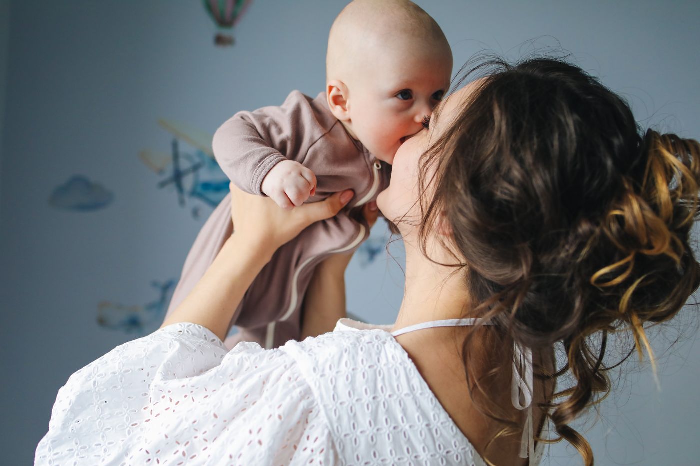 A mother holding her baby close